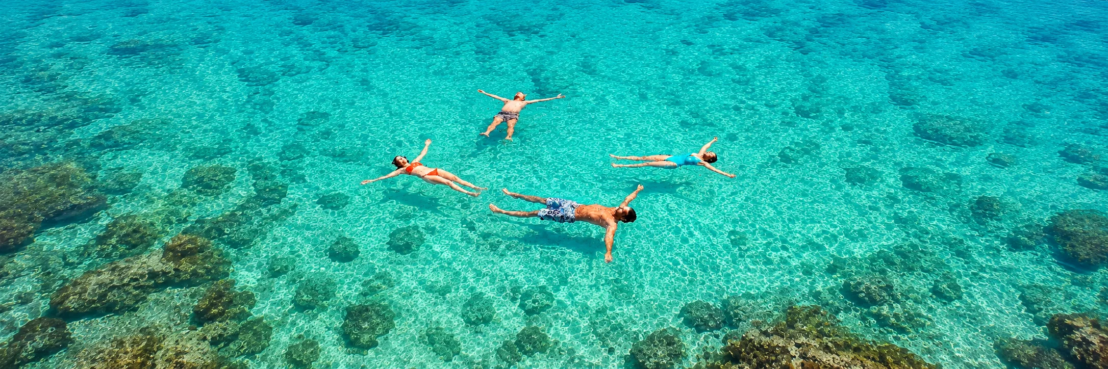 Seaplane arriving at sunset over turquoise waters